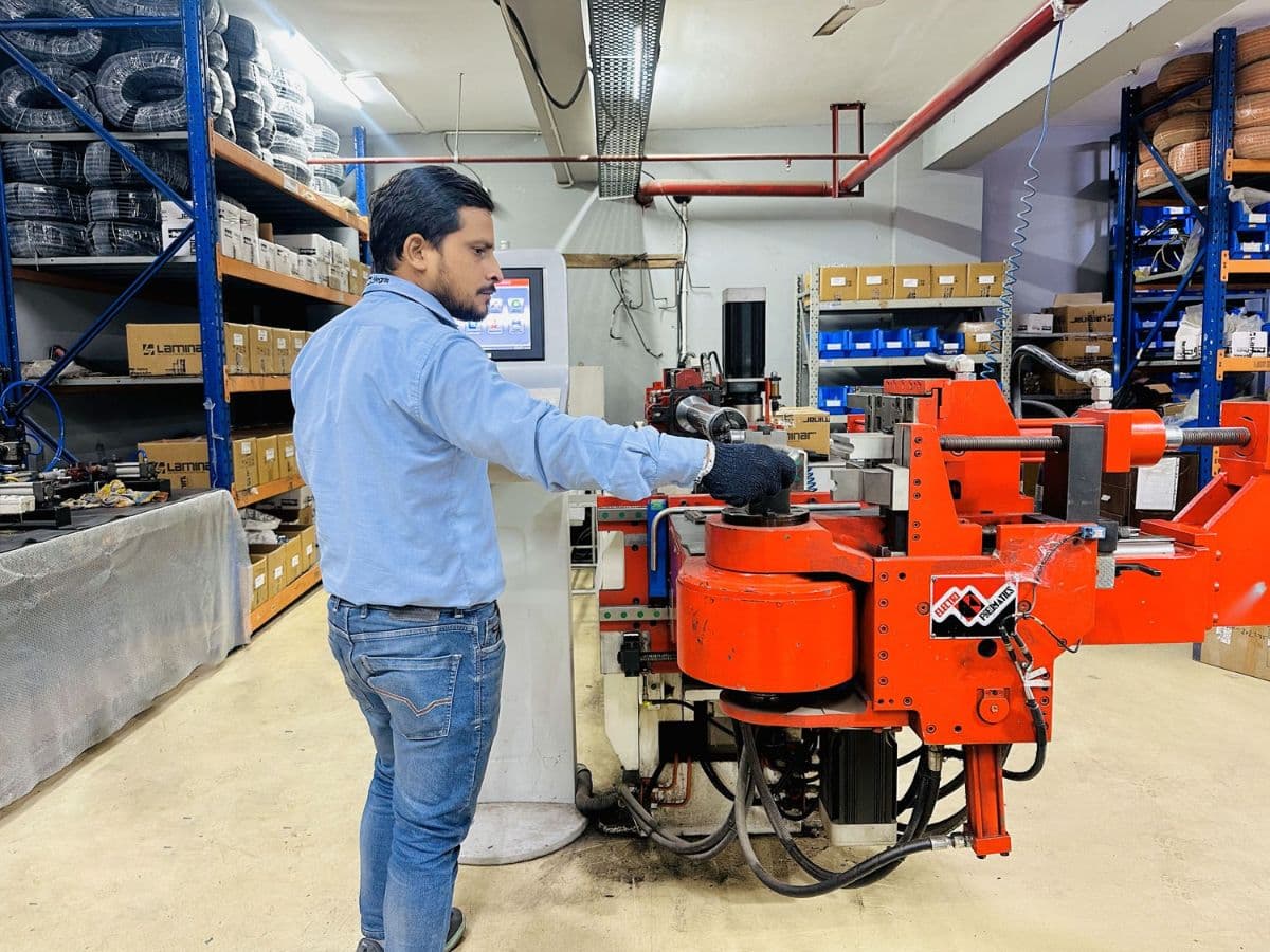 Technician operating manufacturing equipment